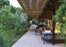 Wooden-deck-wicker-and-iron-pergola-extend-the-living-area-into-the-lush-green-garden-217x155