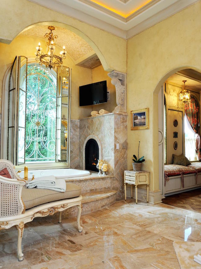 A tub with custom built-in fireplace fit for royalty