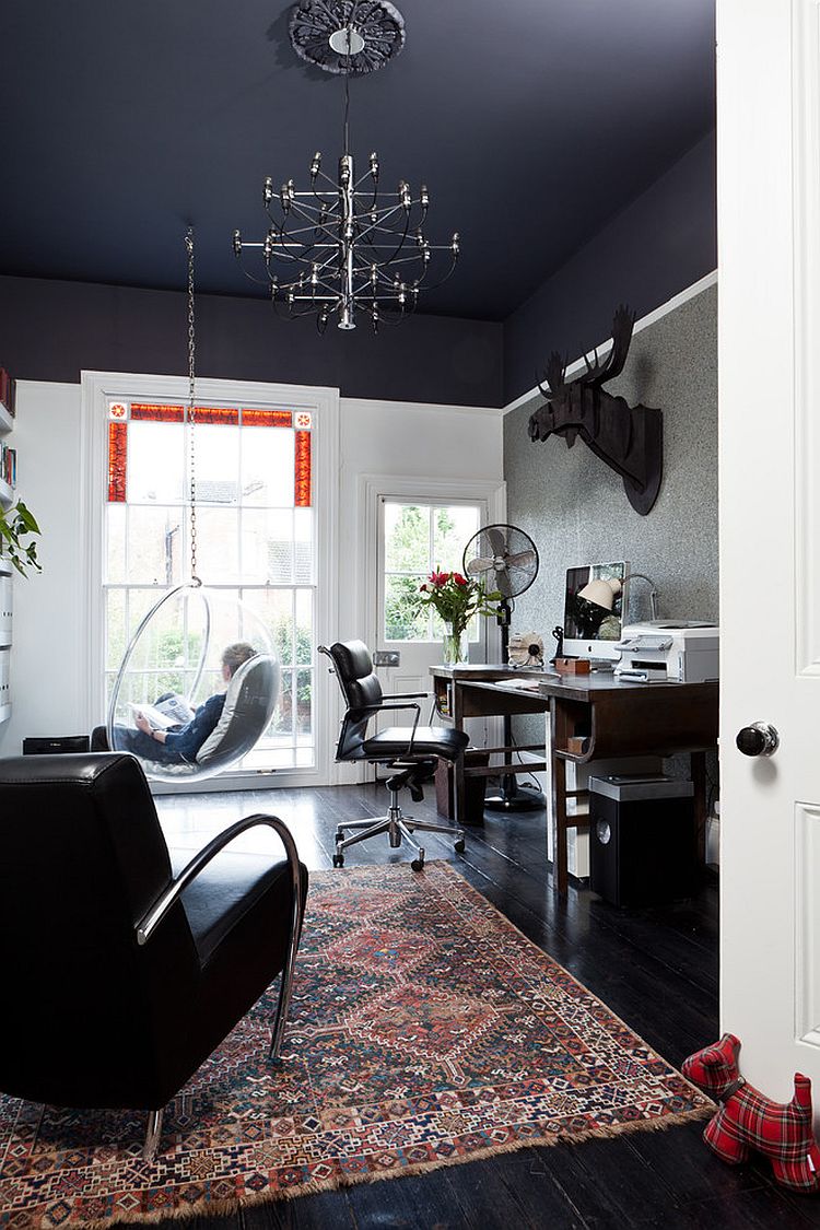 Black ceiling gives the room with high ceiling a visually cozier ambiance