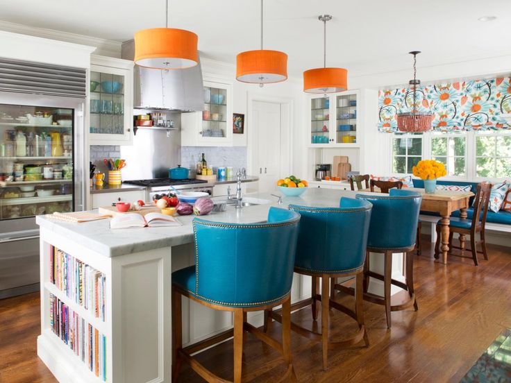 Blue bar stools with curved backs paired with pops of orange