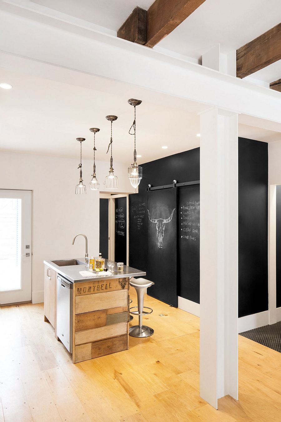 Chalkboard wall in the kitchen along with a tiny island clad in reclaimed wood