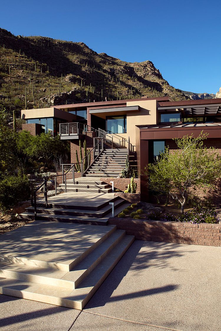 Contemporary entry of the Tucson home with staircase leading to the main living level