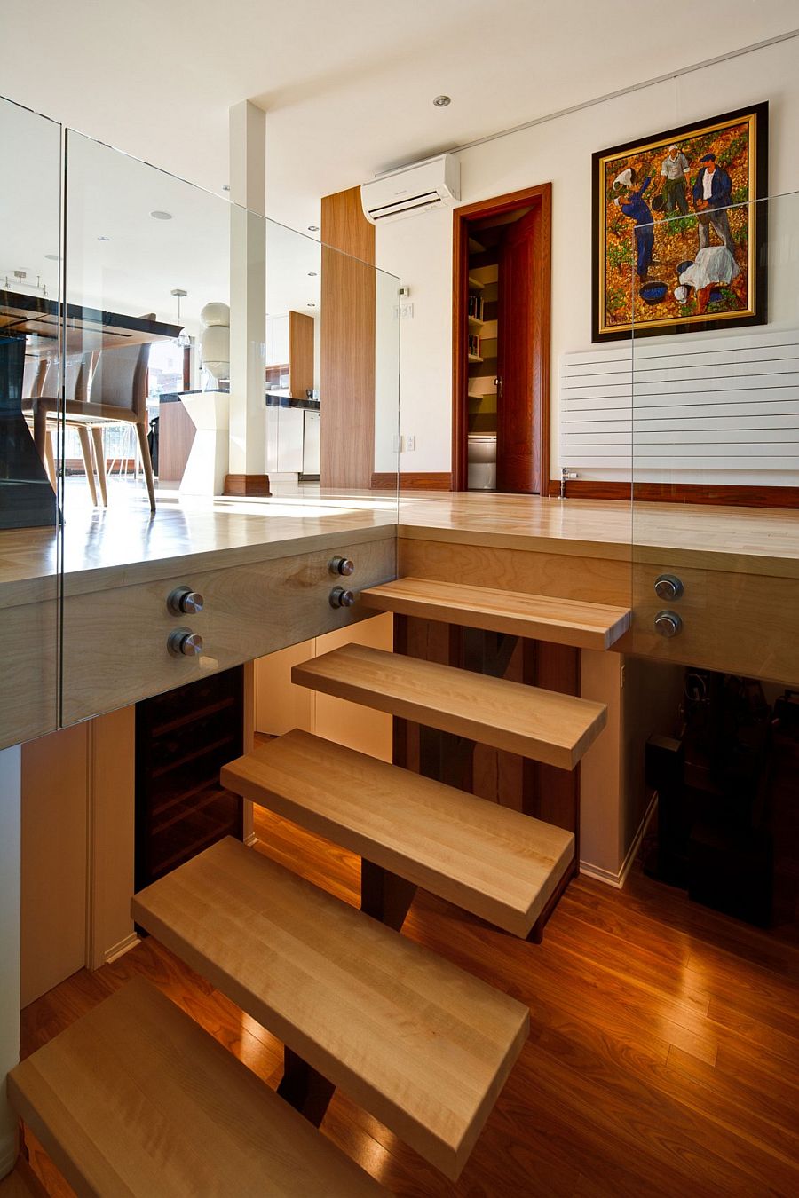 Contemporary wooden staircase leading to the lower private level of the Montreal home