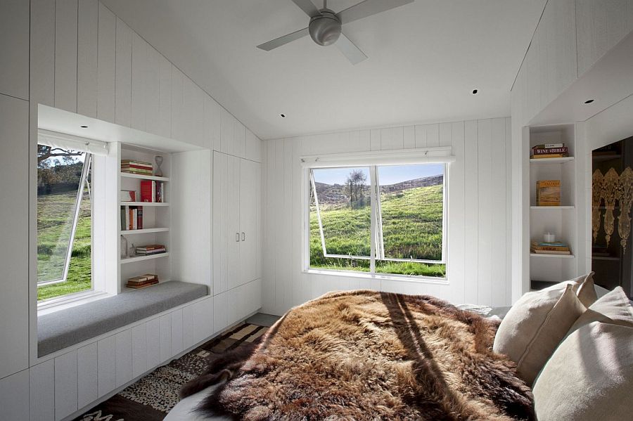 Cozy bedroom in white with window seat and gorgeously framed views