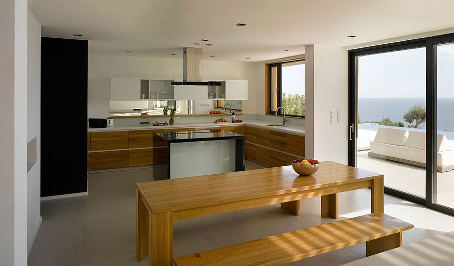 Cozy modern kitchen with wooden shelves and a lovely sea view