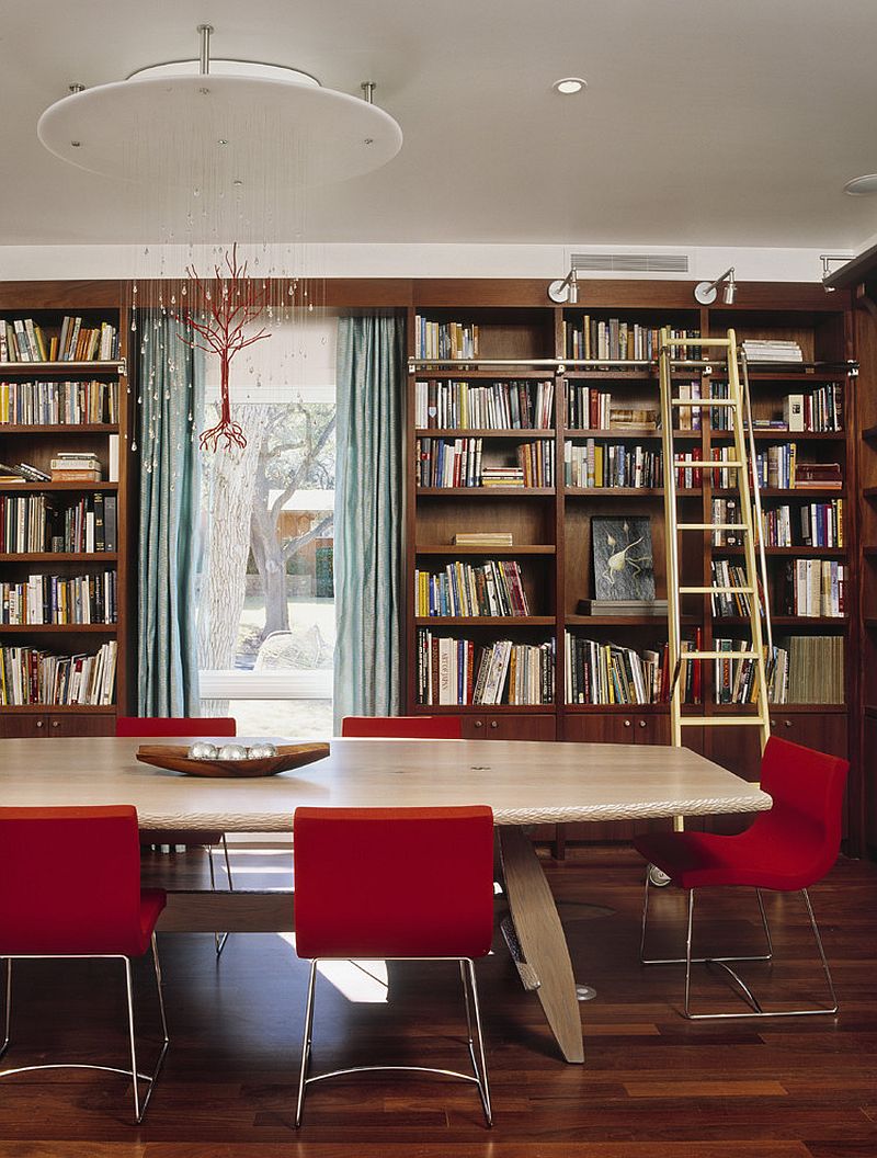 Custom chandelier and fabulous red chairs add color to the home library / dining room [Design: McKinney York Architects]