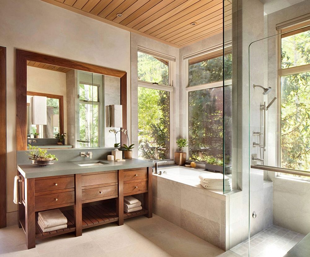Custom vanity in the bathroom clad from walnut adds warmth to the setting