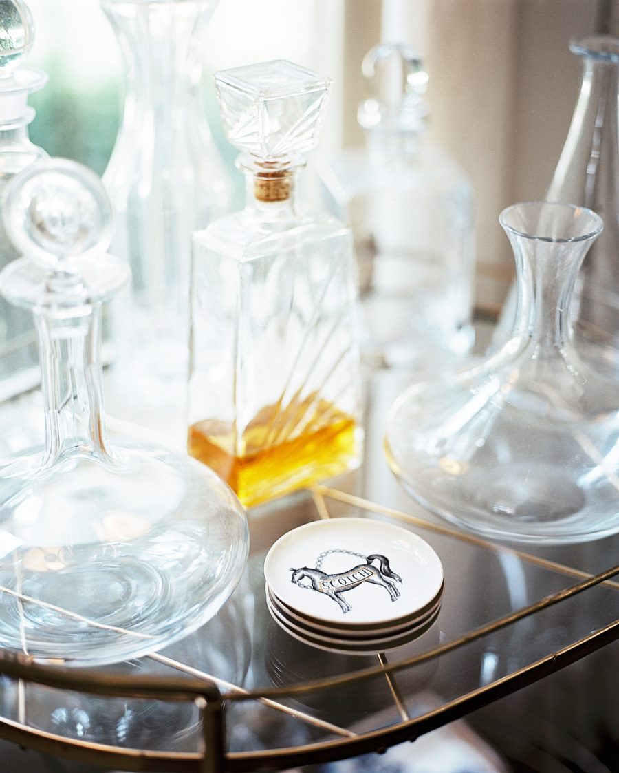 Decanters on a gold-toned bar cart