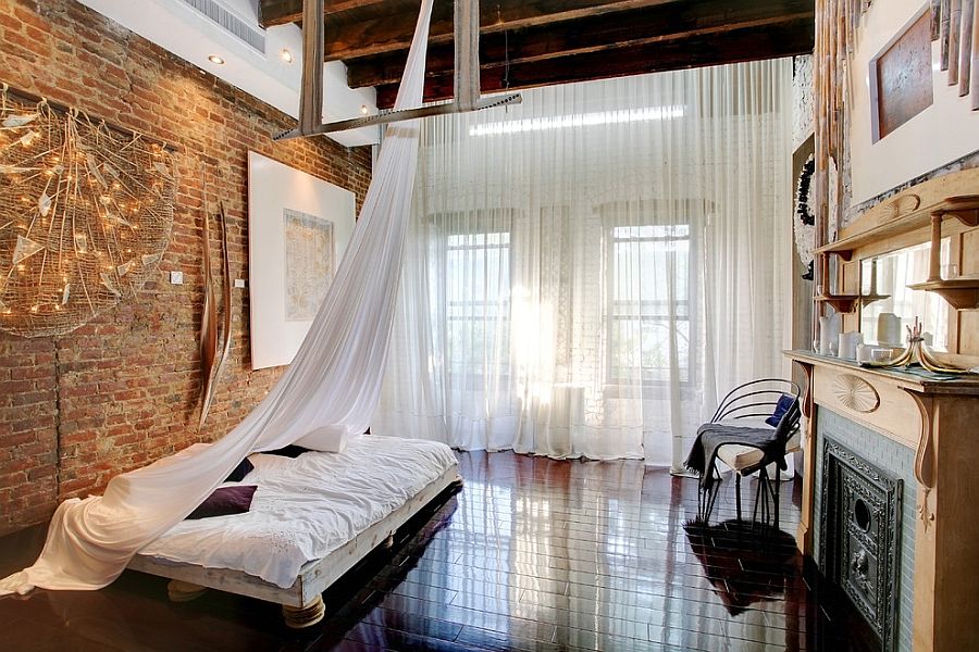 Delicate sheer curtains contrast the rough, exposed brick walls perfectly