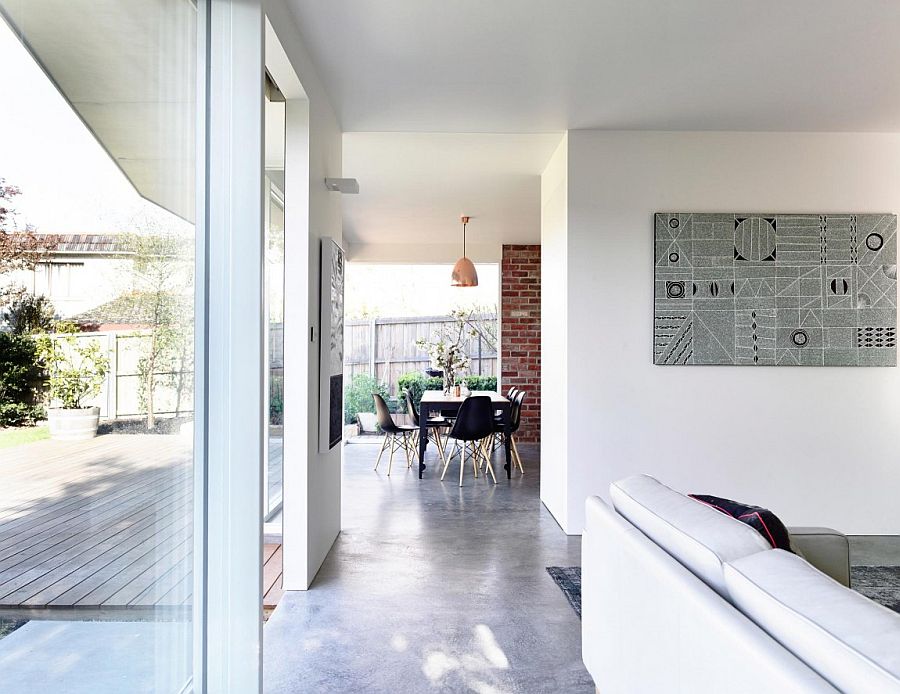 Dining room with metallic pendant and dark dining table chairs