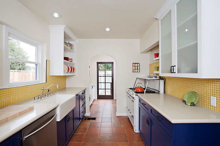 Eclectic kitchen with splashes of blue and yellow with terra-cotta tile floor