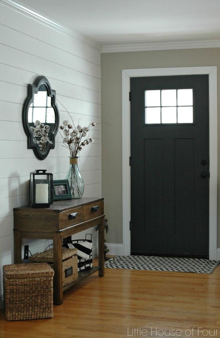 Entryway with a small irregular mirror hung above table