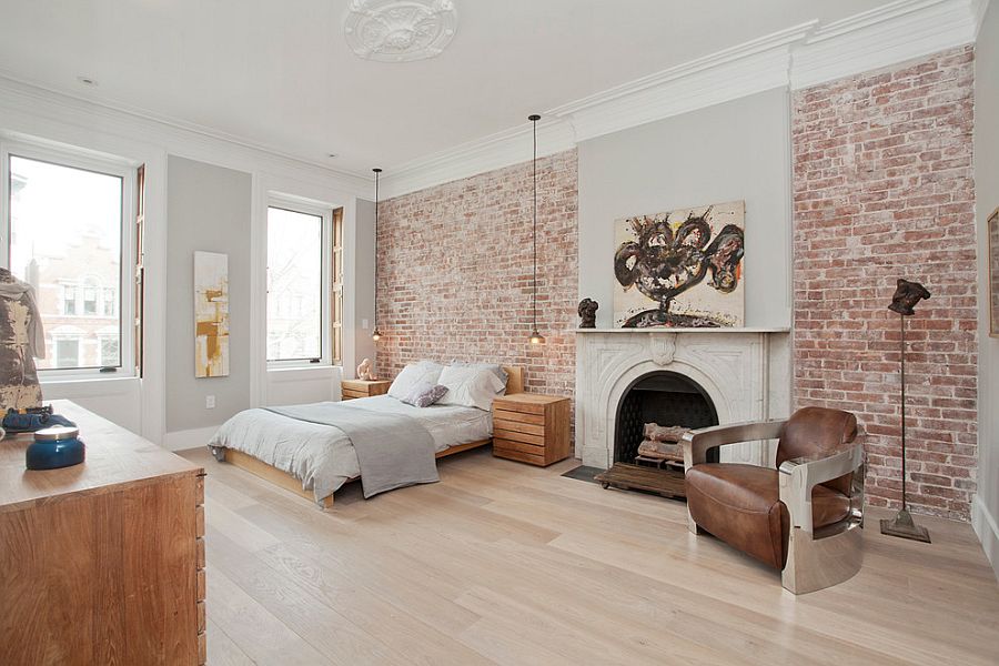 Exposed brick walls and classic fireplace inside the Scandinavian bedroom [Design: Jensen C. Vasil Architect]