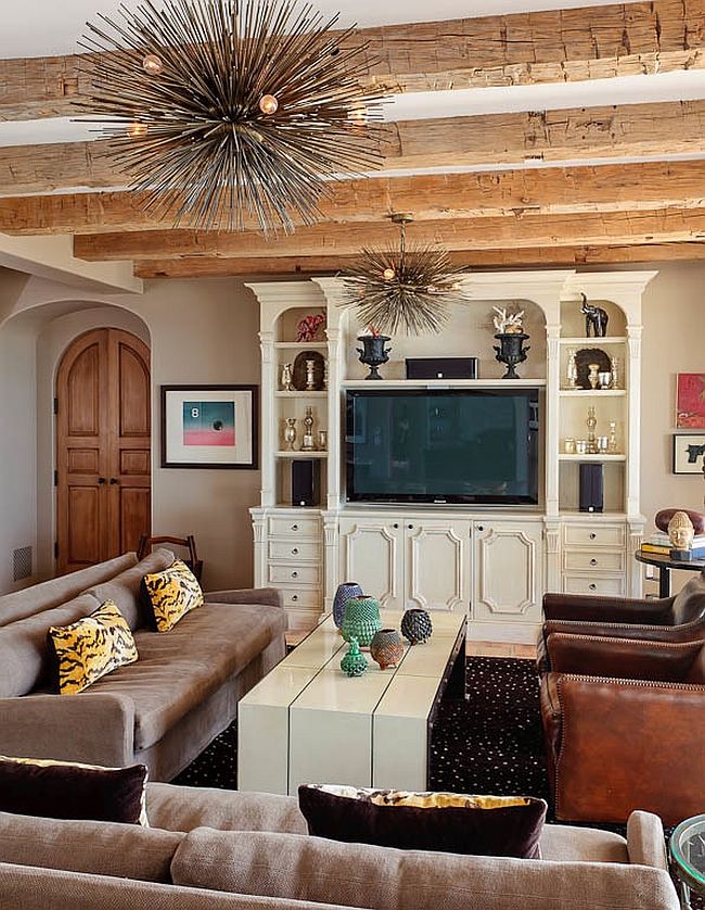 Exposed ceiling beams and Spike chandeliers add contrasting textures to the living room