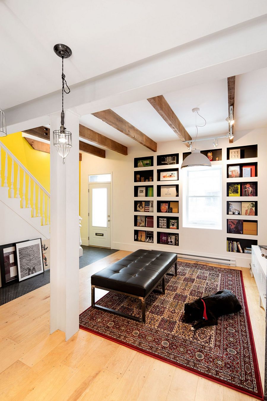 Exposed wooden beams, bookshelves and art work give the interior a distinct character