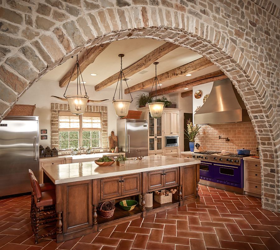 Exquisite kitchen with stone walls and terra-cotta tile herringbone flooring