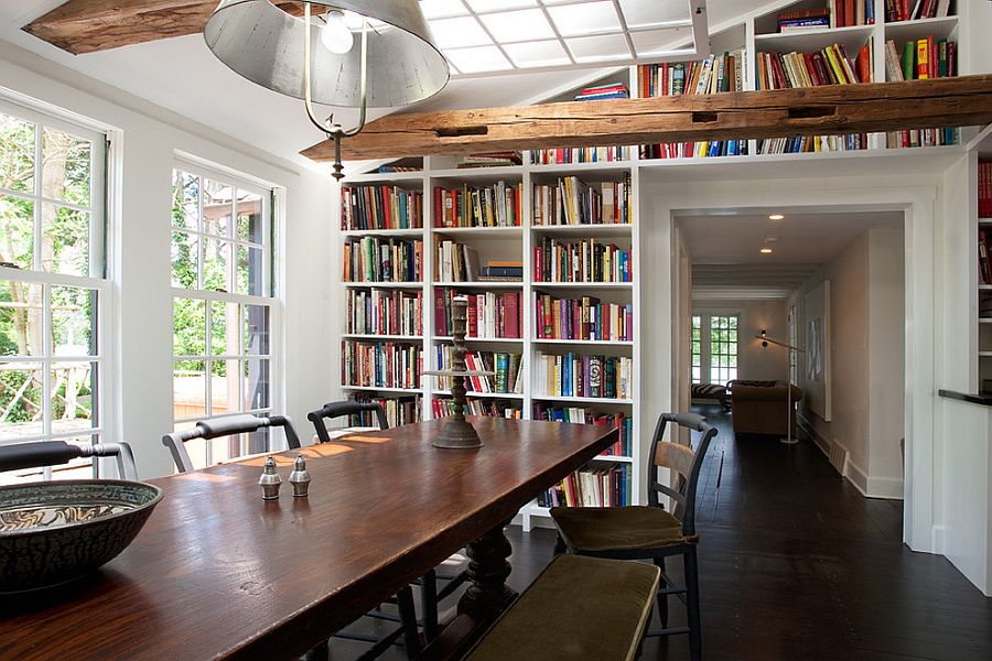 Fabulous farmhouse style dining room with built-in bookshelves in the background