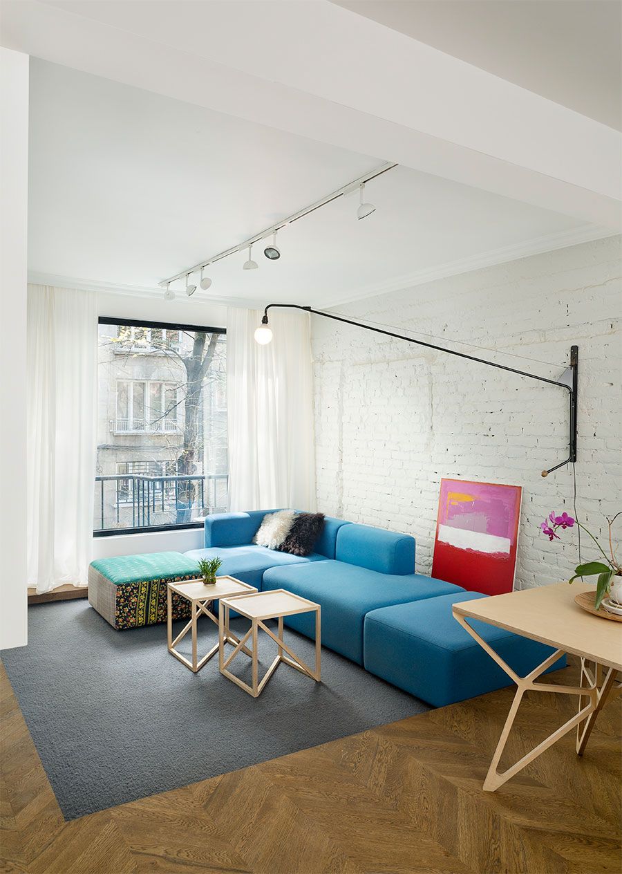 Fabulous modular sofa in blue adds color to the eclectic living space