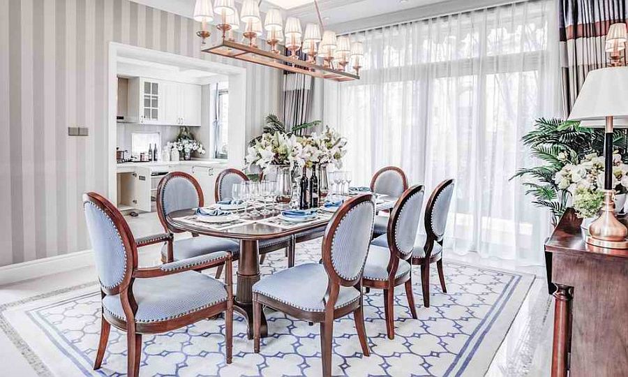 Fabulous wallpaper, drapes and rug in the dining room stitches together contrasting textures