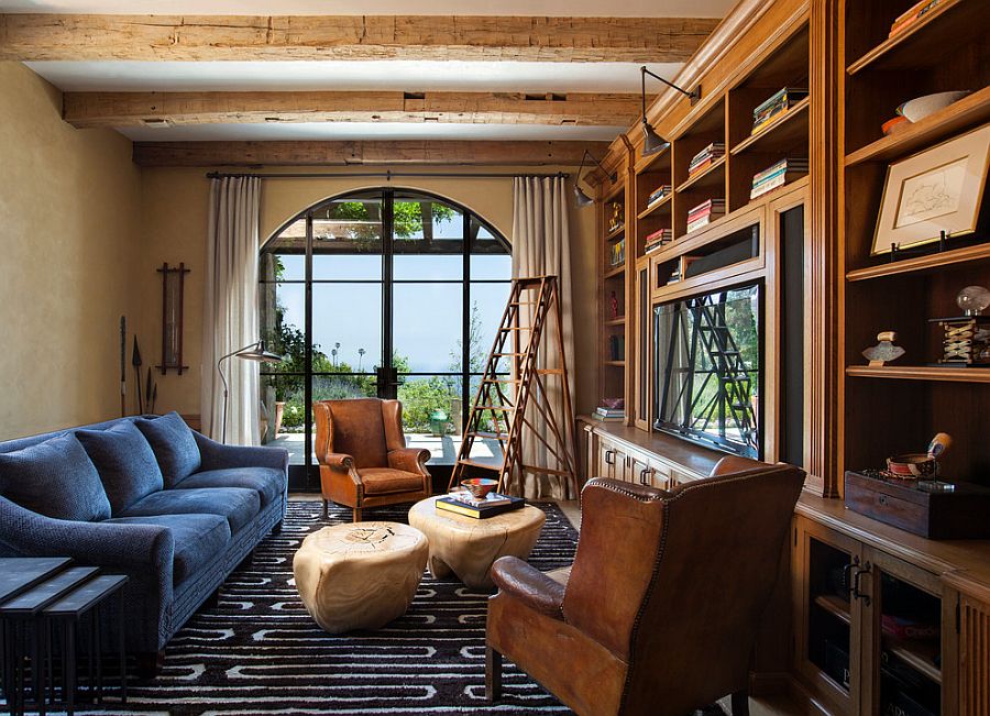 Family room and home library with textured walls and exposed wooden ceiling beams