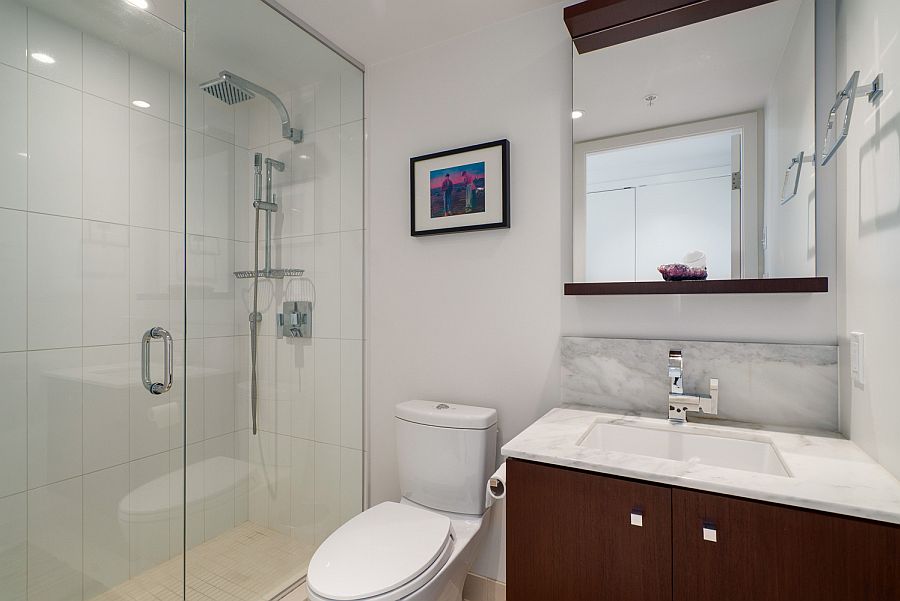 Floating wooden vanity inside the small modern bathroom