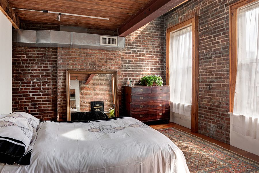 Frame of the mirror and the windows bring a sense of homogeneity to the bedroom