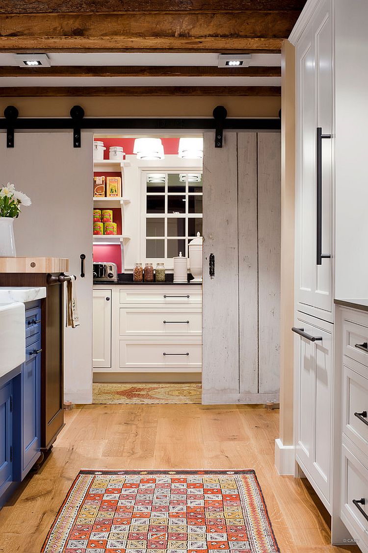 Full-size  pantry with counters and workzone hidden behind sliding barn-style doors