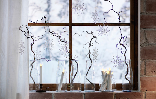 Glass bottles with branches and snowflakes