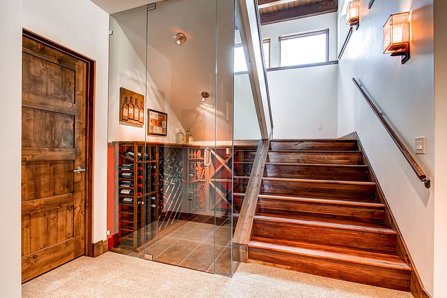 Glass walls turn the space under the stairs into a lovely wine storage area