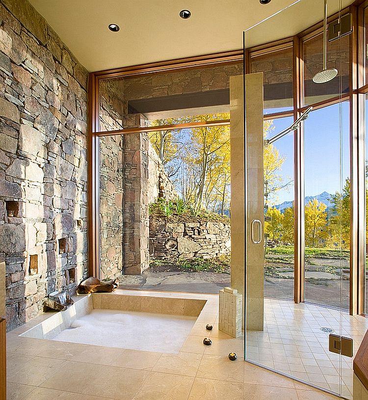 Gorgeous bathroom with natural stone wall and sunken tub