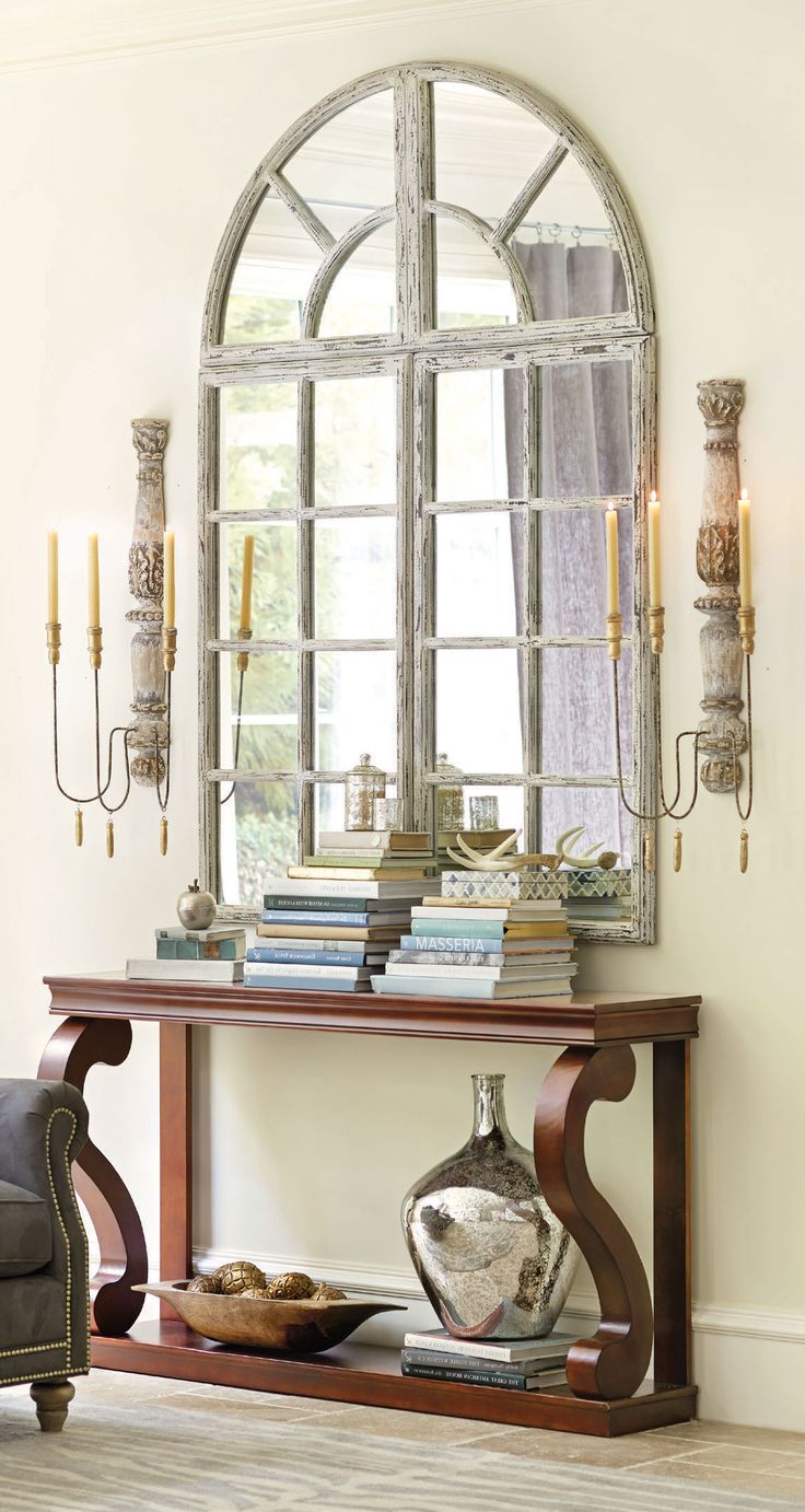 Gorgeous entryway with a Grand Chateau Window Mirror and large scones