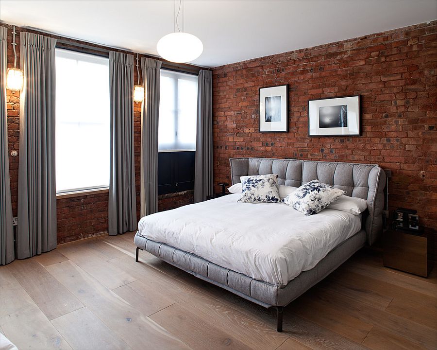 Gray brings contemporary elegance to the bedroom with exposed brick walls [Design: Peter Landers Photography]