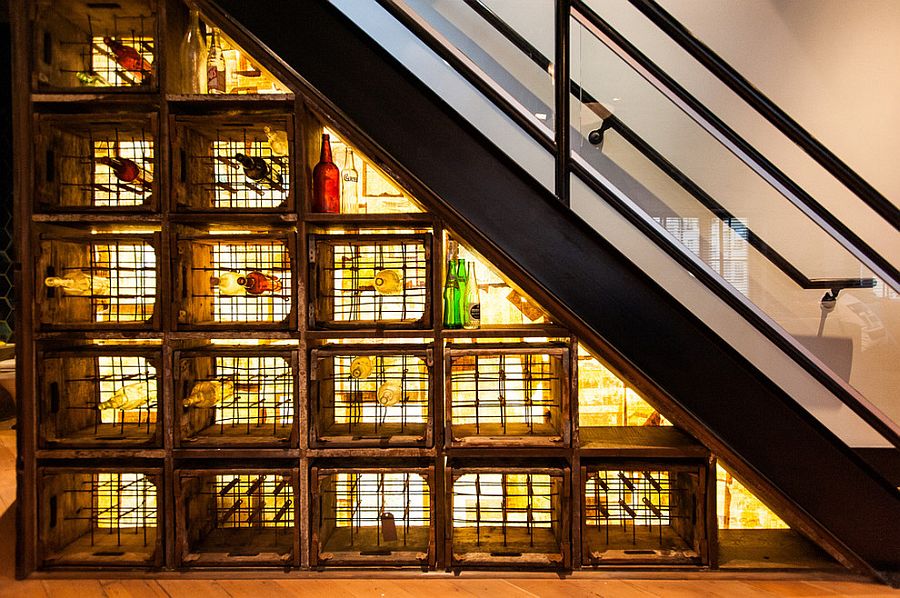 Industrial wine cellar under stairs with crates and distressed barn doors