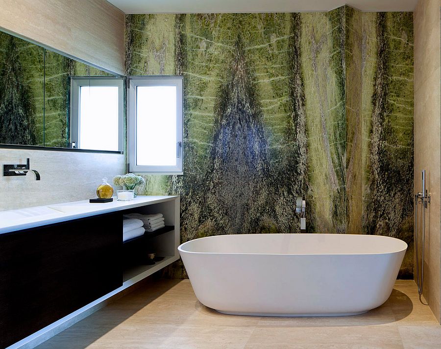 Irish green marble creates a vivacious accent wall in the contemporary bathroom