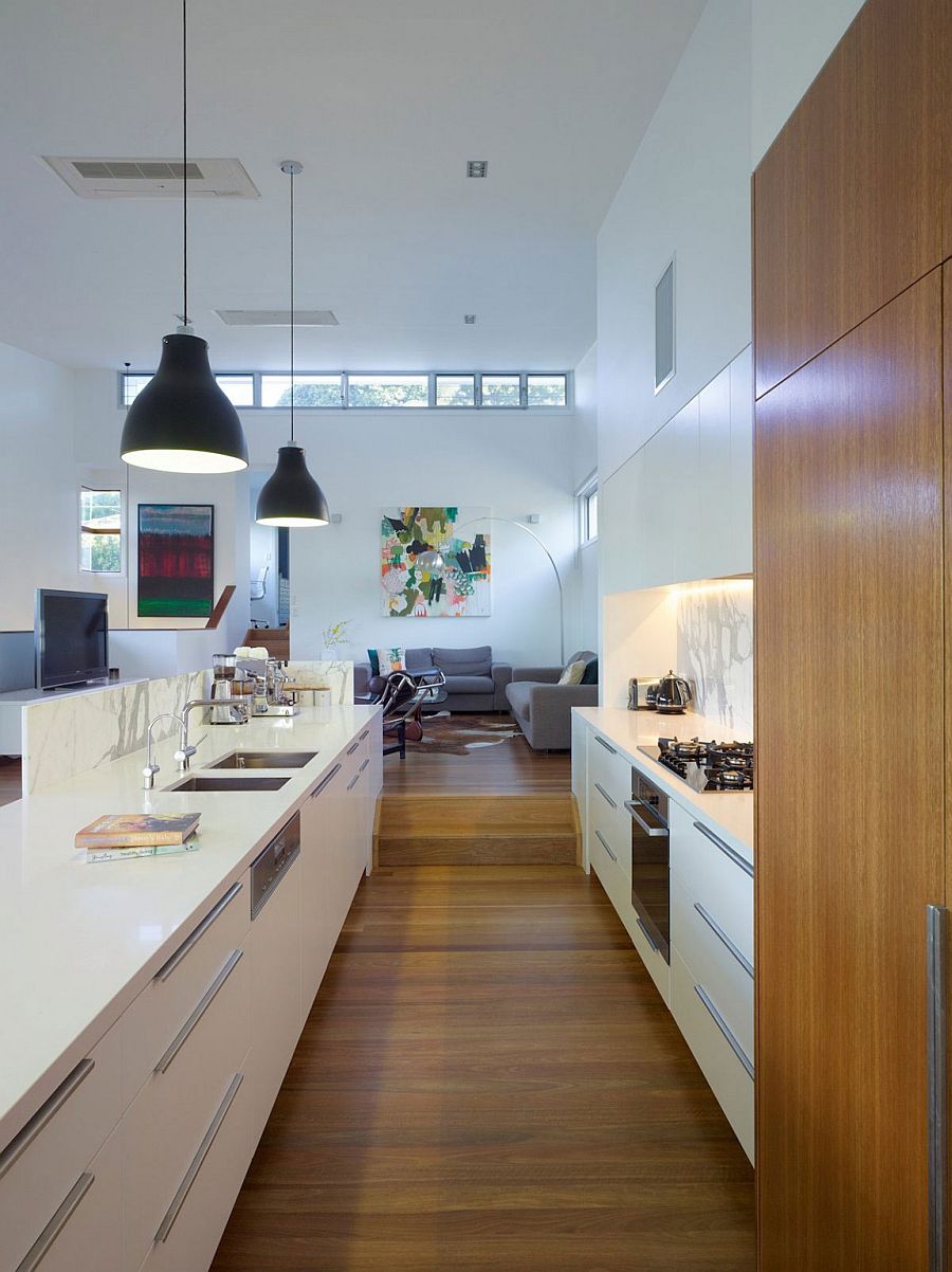 Kitchen in white with marble and stone finishes and wooden shelves