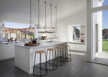 Kitchen-in-white-with-slide-away-windows-that-open-towards-the-garden-217x155
