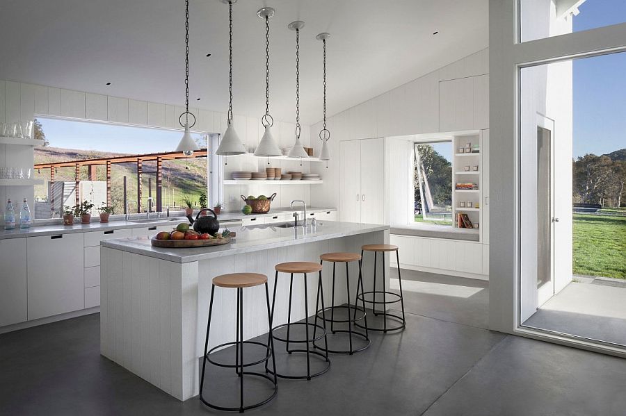 Kitchen in white with slide-away windows that open towards the garden