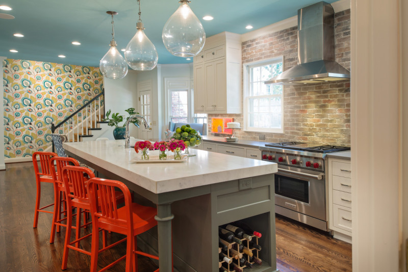 Kitchen with a blue ceiling and bright orange bar stools