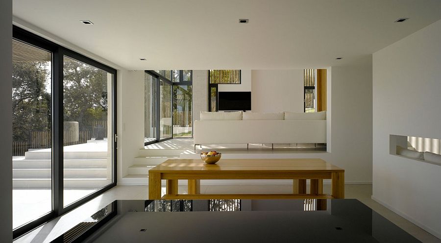 Large, framed glass doors connect the living area with the lavish deck outside