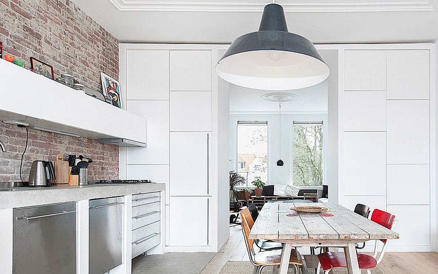 Large industrial style pendant in gray adds personality to the small dining room kitchen combo