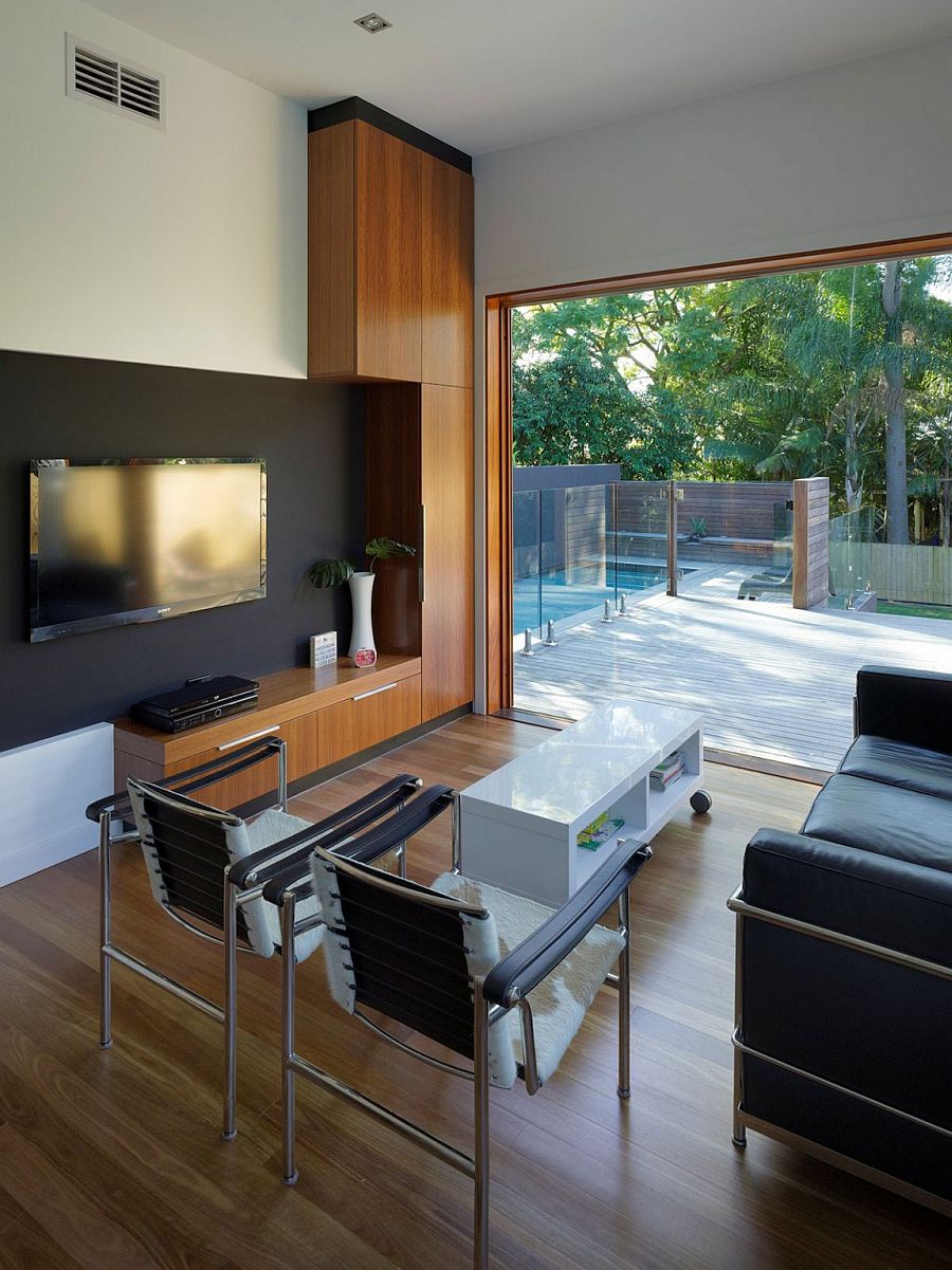 Living area of the modest family home in Australia overlooking the pool and deck