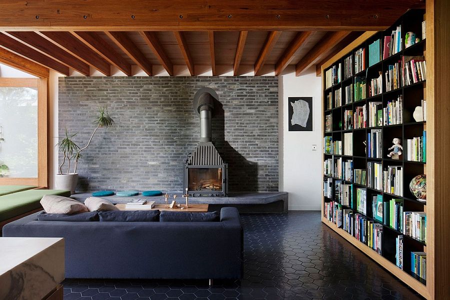 Living area with dark brick wall backdrop and large bookshelves