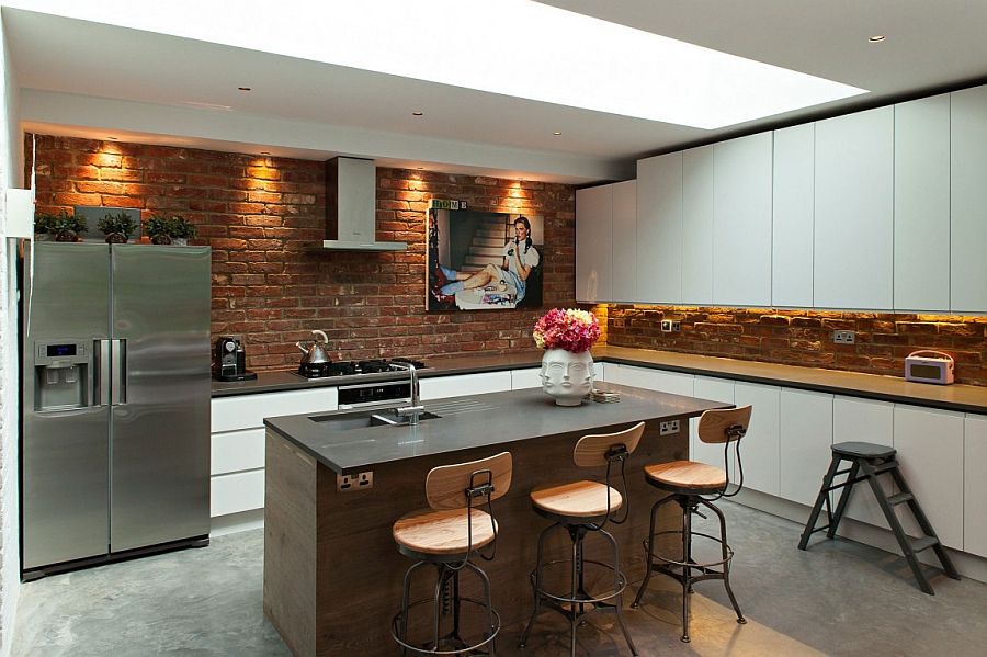 Modern kitchen with brick walls and contemporary cabinets in white