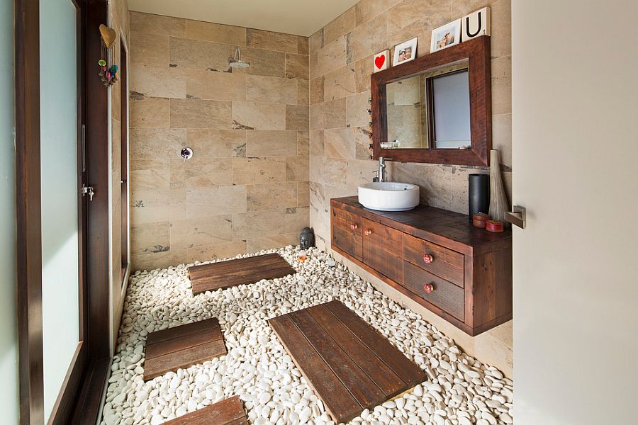 Natural stone and pebbles create an exotic, tropical style bathroom