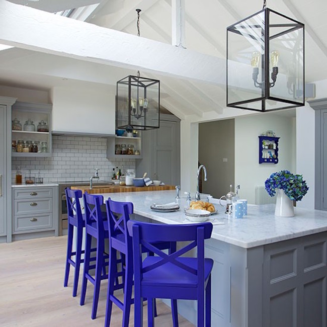 Neutral kitchen with royal purple bar stools