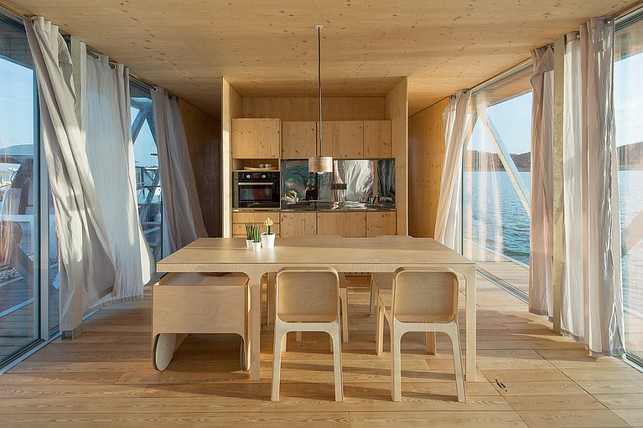 Open plan living area with dining space and kitchen inside the uber-cool floating house