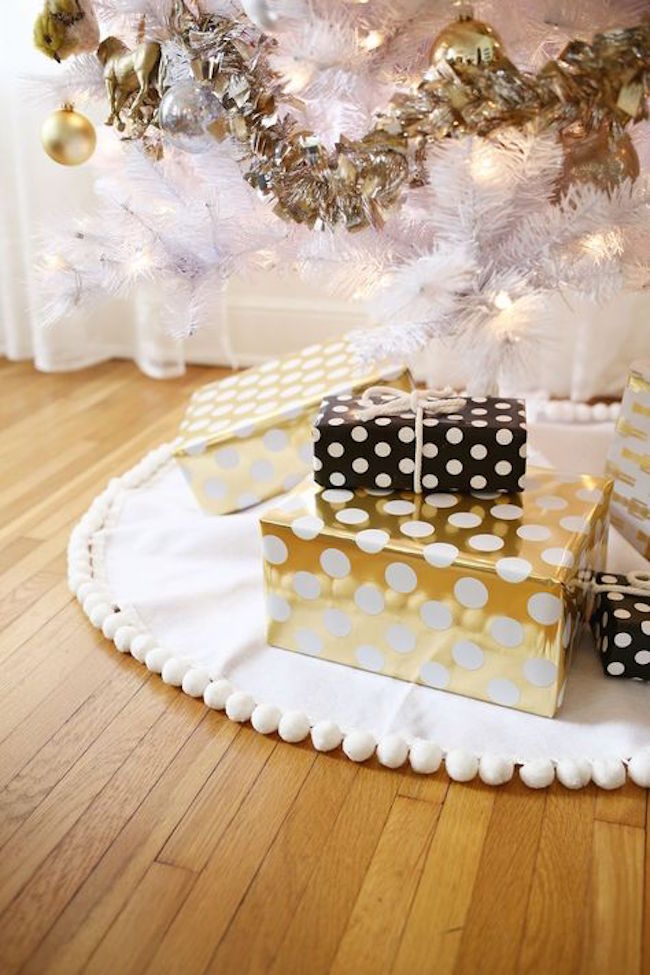 Polka dot gift wrapping paper in gold, black, and white