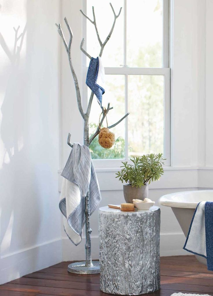 Recycled silver metal branch coat tree in bathroom