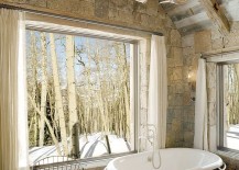 Rustic-bathroom-with-stone-wall-vintage-bathtub-and-antler-chandelier-217x155