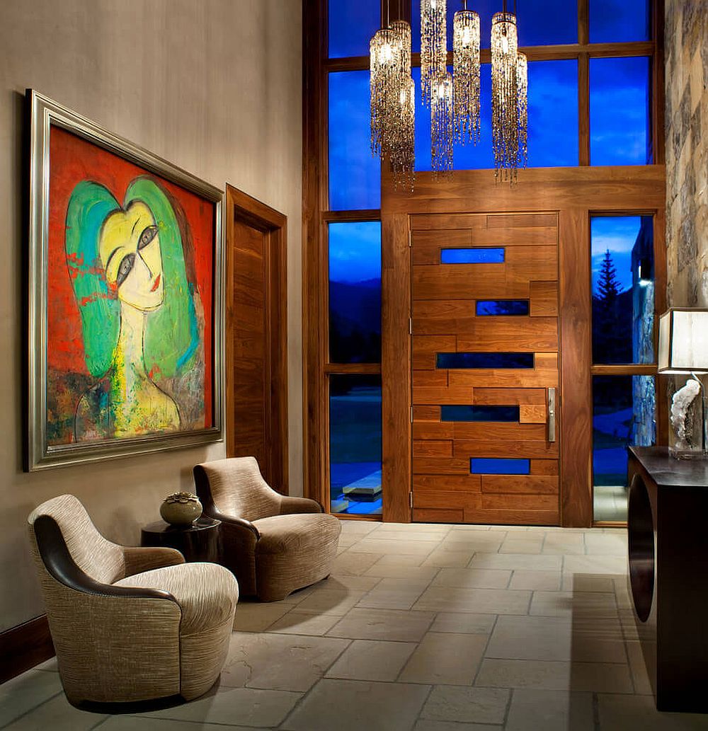 Rustic modern entry with unique door, colorful artwork and a lovely chandelier